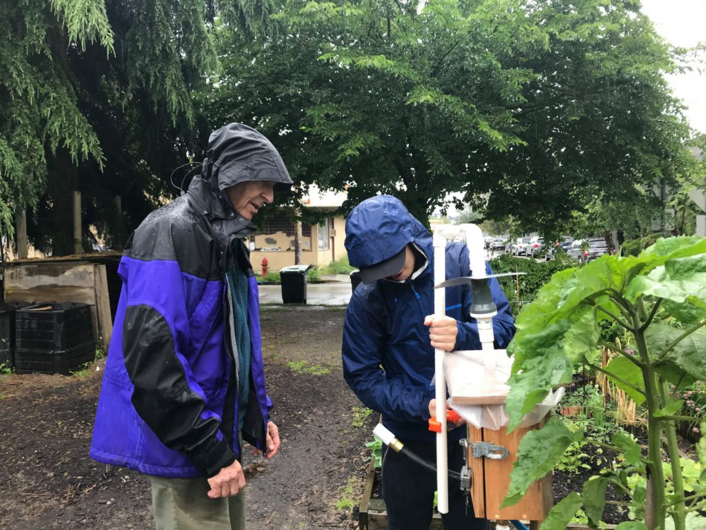 George and Volunteer building water system for plants