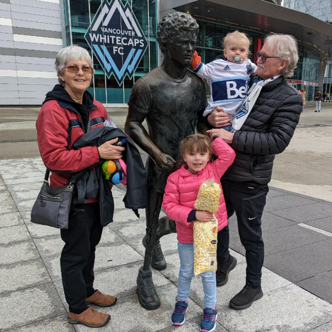 Posing with Terry fox with his wife and grandchild at BC Place